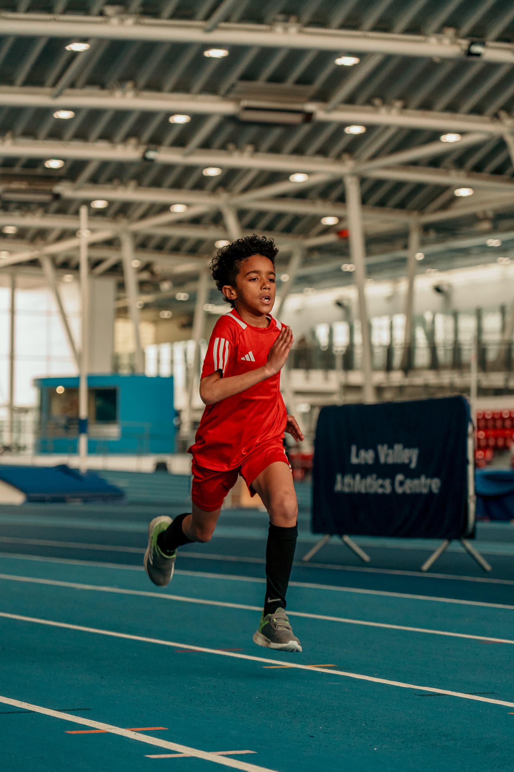 Young athlete preparing to start a sprint on a track